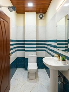 a bathroom with a toilet and a sink at Hotel Sky Palace Airport Zone in Hyderabad +36 photos