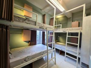 a room with three bunk beds in it at Little Malang Hostel小玛瑯青年旅舍 in Malang +31 photos