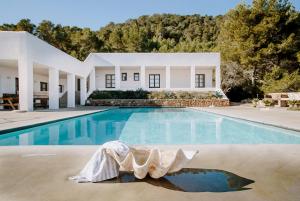 a house with a swimming pool in front of it at Villa Arenas in Sant Josep de sa Talaia
