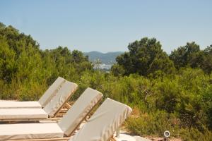 a group of lounge chairs sitting on top of a hill at Villa Arenas in Sant Josep de sa Talaia