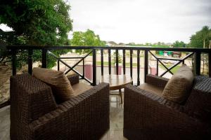 a balcony with two chairs and a table on a balcony at Aniyak Guest House in Sekondi-Takoradi