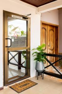 a front door of a house with a potted plant at Aniyak Guest House in Sekondi-Takoradi