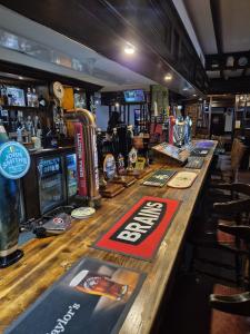 a bar with a long wooden counter in a pub at The Crewe Arms Hotel in Crewe