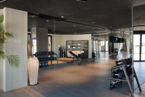 a gym with a lot of chairs and mirrors at Amare Beach Hotel Sancti Petri - Adults Recommended in Chiclana de la Frontera