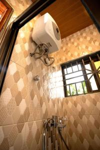 a bathroom with a shower and a sink at Aniyak Guest House in Sekondi-Takoradi +11 photos