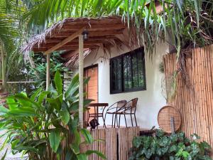 a house with two chairs and a table in front of it at Star Fish Cozy House in Ban Nua