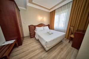 a bedroom with a bed with two candles on it at Grand Hotel Seferoğlu in Istanbul +26 photos