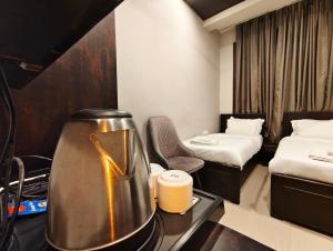 a hotel room with two beds and a juicer at The Core in Kohīma