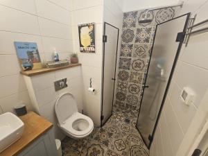 a small bathroom with a toilet and a shower at Ido and Racheli in Yonatan +24 photos