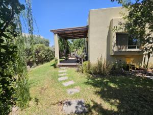 a house with a pathway leading into a yard at Ido and Racheli in Yonatan