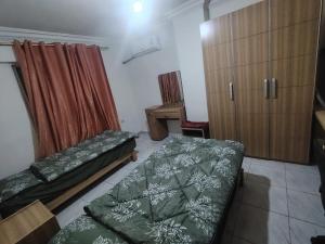 a room with two beds and a desk in it at شقة خلف السيفوي in Irbid +3 photos