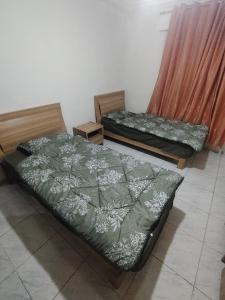 two beds sitting next to each other in a room at شقة خلف السيفوي in Irbid