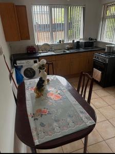 a kitchen with a table with a table cloth on it at Quiet room Nr 1 in Coventry