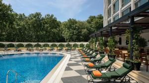 a hotel pool with lounge chairs and a hotel at InterContinental Istanbul by IHG in Istanbul