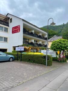 a hotel with a car parked in front of it at Hotel-Café Residenz Bad Bertrich in Bad Bertrich