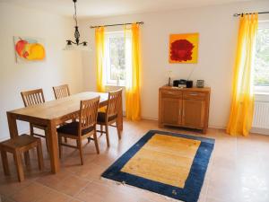 a dining room with a wooden table and chairs at Lindenhof Hahn in Blankenrath