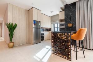 a kitchen with a counter with a pile of fire wood at Amber Hospitality - Blvd in Riyadh
