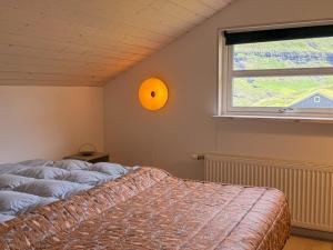 a bedroom with a bed and a window at Sea & Mountain View 4 Bedroom in Leynar
