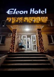 a sign for an open door to a hotel at Eleon in Almaty