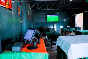 a room with a desk with a computer on a table at Martin Aviator Hotel in Kigali