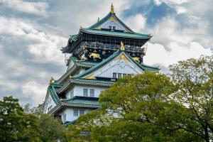 a tall tower with a clock on the top of it at New Osaka Hotel Shinsaibashi in Osaka