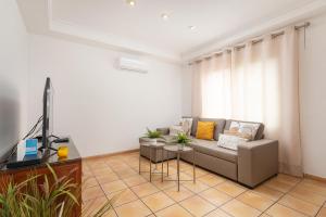 a living room with a couch and a television at Ca S'Ingles in Alcudia