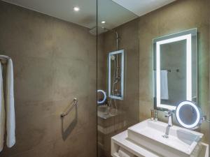 a bathroom with a sink and a mirror at Novotel Mexico City Toreo in Mexico City