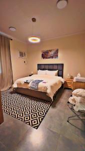 a bedroom with a large bed and a rug at أوريانا Oriana in Jeddah