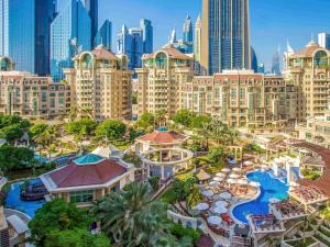 an aerial view of a resort with a city at Swissôtel Al Murooj Dubai in Dubai