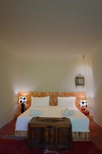 a bedroom with a large bed with a wooden table at MORO Marrakech Boutique Hôtel in Marrakesh +146 photos