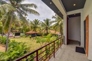 a balcony view of a resort with palm trees at Orange Vista Resort Coorg in Kushālnagar