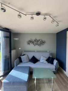 a living room with a couch and a table at Maison à Westende in Middelkerke