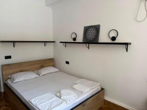 a bed in a room with shelves on the wall at Golden Sunset Batumi Private Pool Villa in Batumi