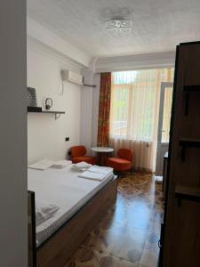 a bedroom with a bed and a table and chairs at Golden Sunset Batumi Private Pool Villa in Batumi