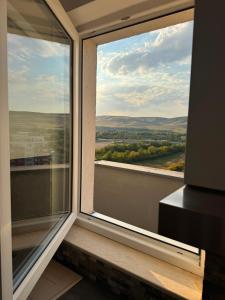 a large window with a view of the countryside at Apartament Cluj in Floreşti