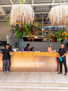 two men standing in front of a counter with plants at Rockstar Beach Apartments in Bangrak Beach +67 photos
