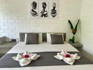a bedroom with a bed with two flowers on it at Ima House in Ahangama