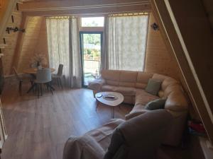 a living room with a couch and a table at durmitor's golden peace in Šavnik