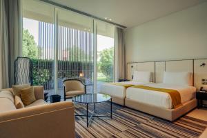 a hotel room with a bed and a couch at Al Zorah Beach Resort in Ajman 