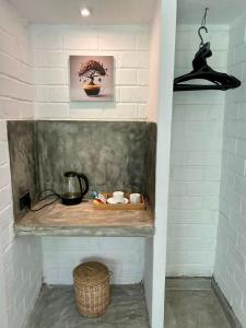 a shelf in a room with a basket and a plant at Ima House in Ahangama