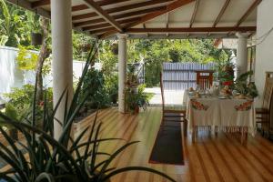 a dining table under a pergola in a garden at Nature Beat villa in Mirissa
