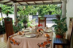 a table with plates and utensils on top at Nature Beat villa in Mirissa +51 photos