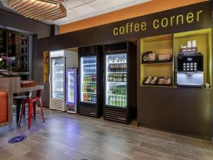 a coffee corner in a restaurant with two refrigerators at ibis budget Lima Miraflores in Lima