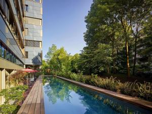 a swimming pool in front of a building at 25hours Hotel Zürich West in Zurich