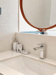 a bathroom sink with a mirror and a sink at Studio Apartment by Sunshine Beach in Layan Beach +15 photos