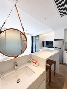 a bathroom with a sink and a mirror at Studio Apartment by Sunshine Beach in Layan Beach
