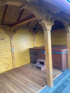 a large wooden room with a bench in the middle at Cabana Magura Mare Belis in Călăţele