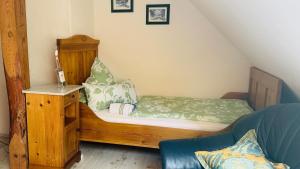 a small room with a bed and a chair at Gästehaus Peerhus Dönsel - buern in Rehden