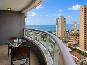 a balcony with a table and a view of the ocean at Studio Iracema by Holiday Stays in Fortaleza