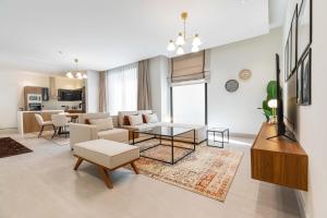 a living room with a couch and a table at Amber Hospitality - Blvd in Riyadh